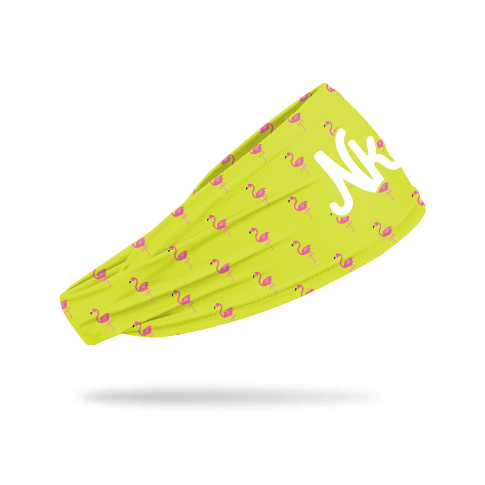 Photo of a yellow headband decorated with a pink flamingo illustration in a pattern on a white background.
