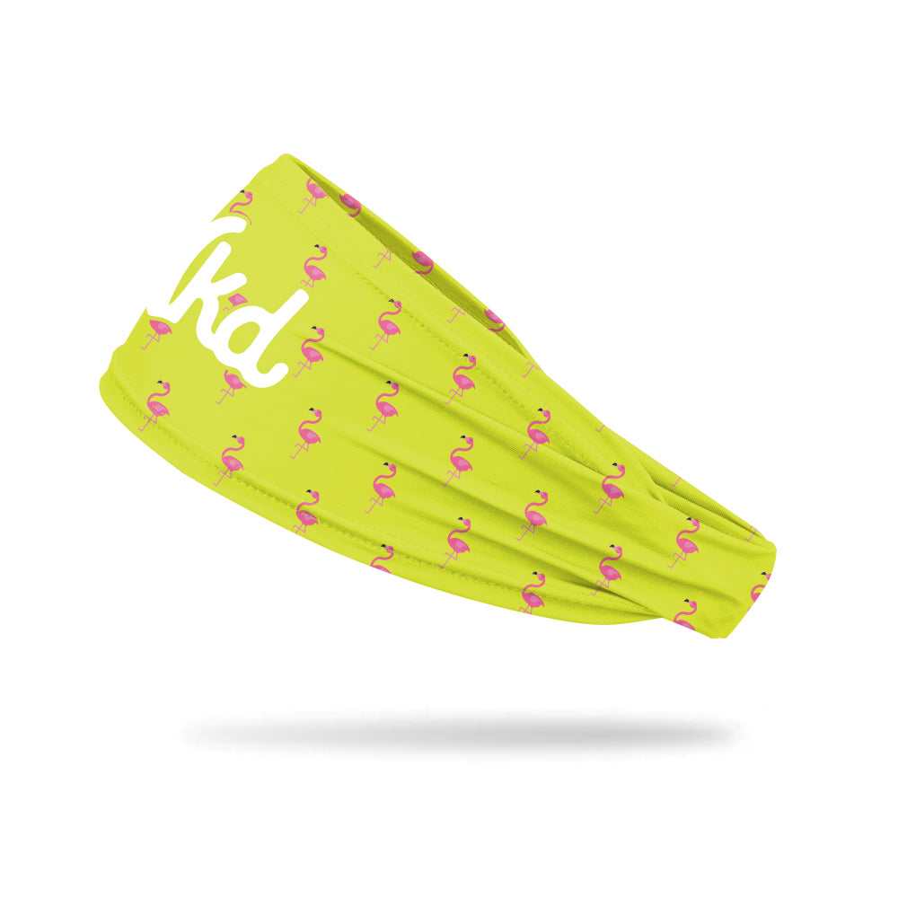 Photo of a yellow headband decorated with a pink flamingo illustration in a pattern on a white background.