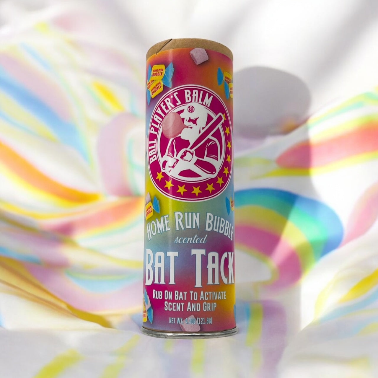 Product photo of the ball players balm home run bubble scented Bat Tack on a multicolored background.