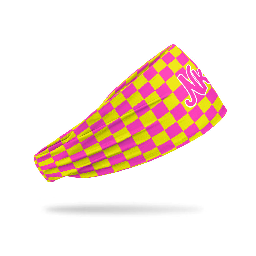 Photo of a headband with a pink and yellow checkerboard pattern floating on a white background.