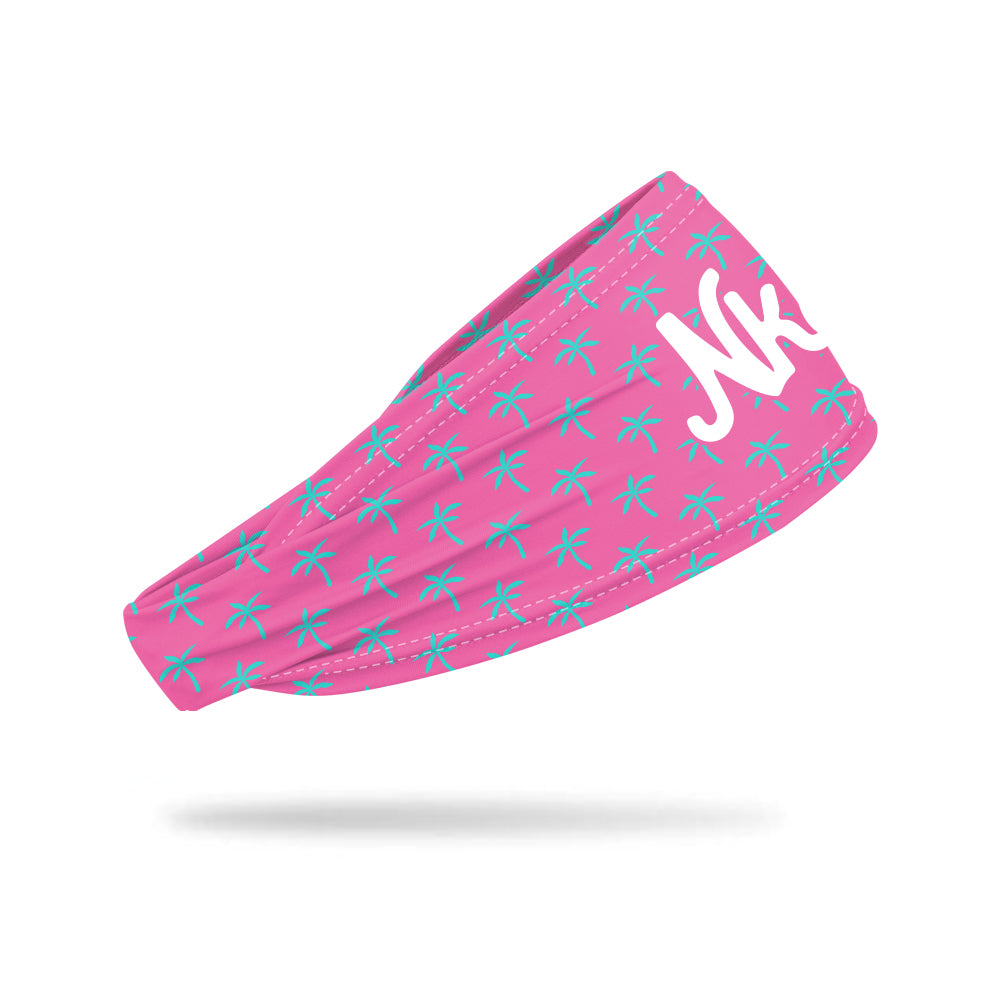 Photo of a pink headband decorated with a light blue palm tree on a white background.