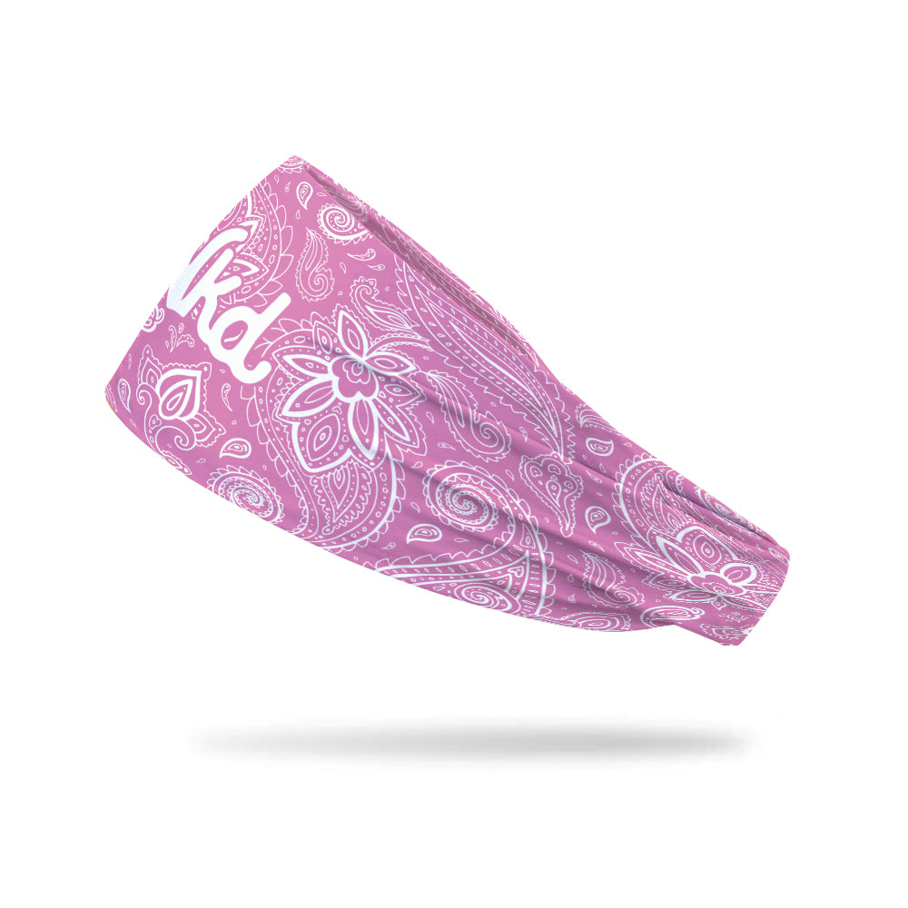 Photo of pink headband decorated a white paisley pattern floating on a white background.