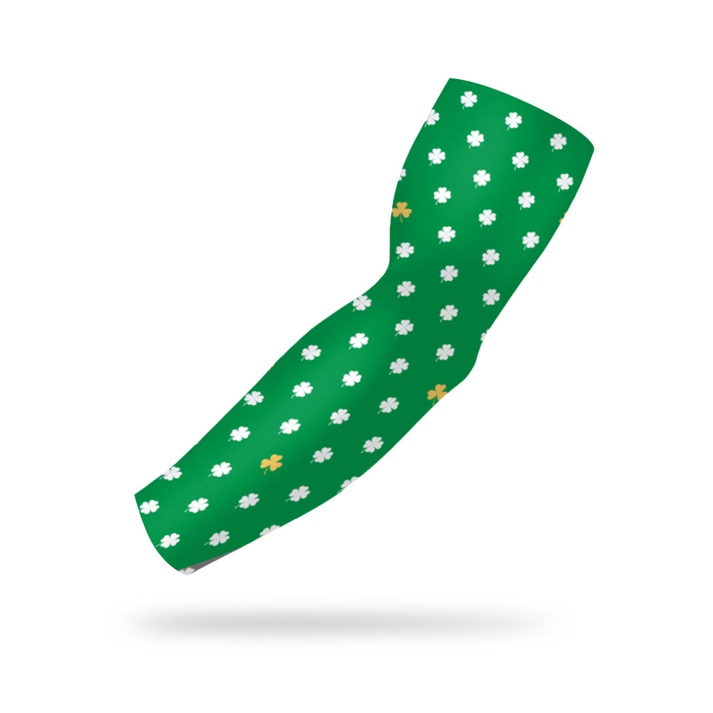 Photo of a green arm sleeve with a shamrock pattern in green and gold on a white background.