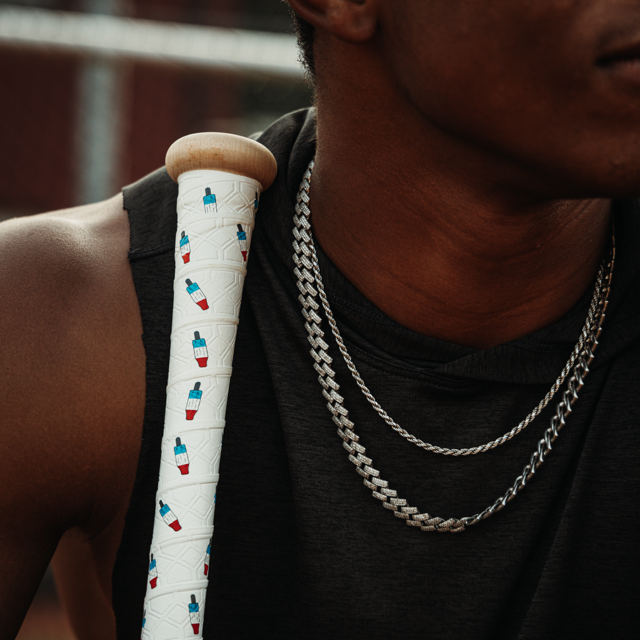 Photo of a man with a wooden bat leaning against his shoulder wrapped with the American treat bat grip