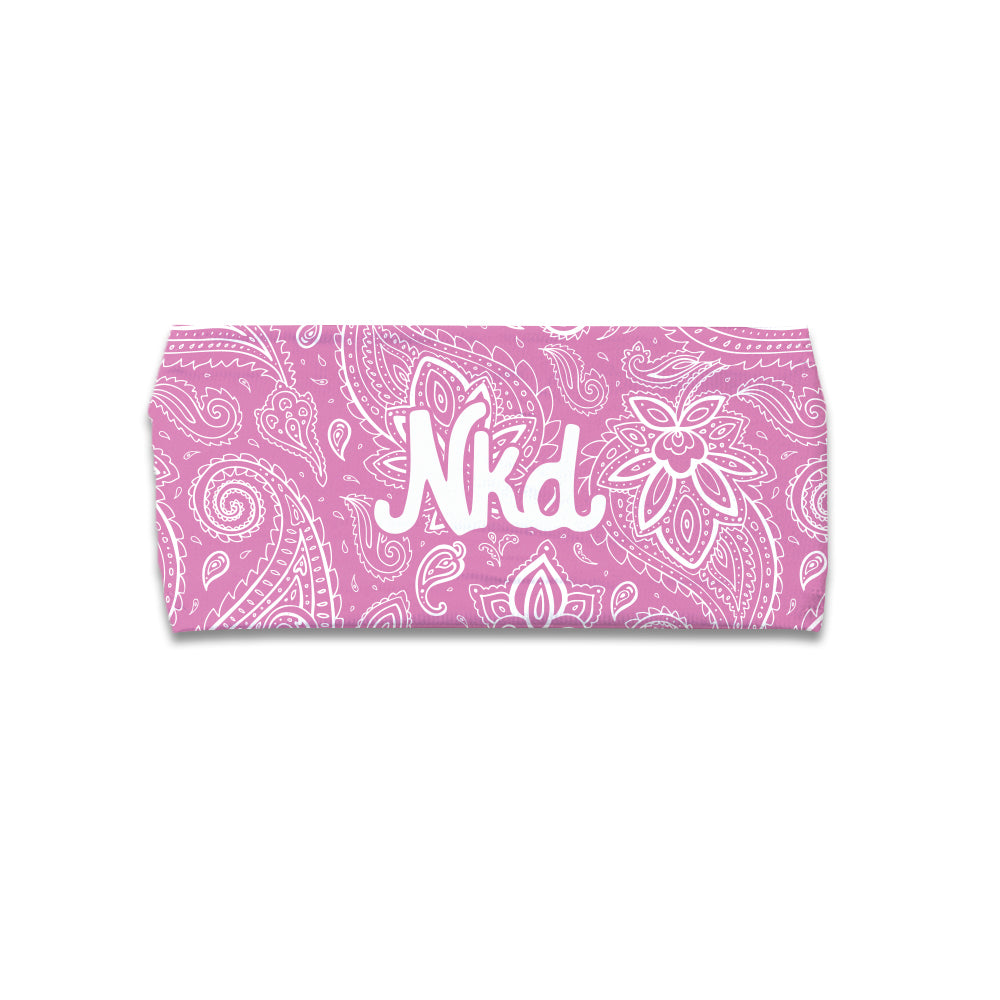 Photo of a pink headband decorated with a white paisley pattern and the letters NKD in the middle on a white background. 