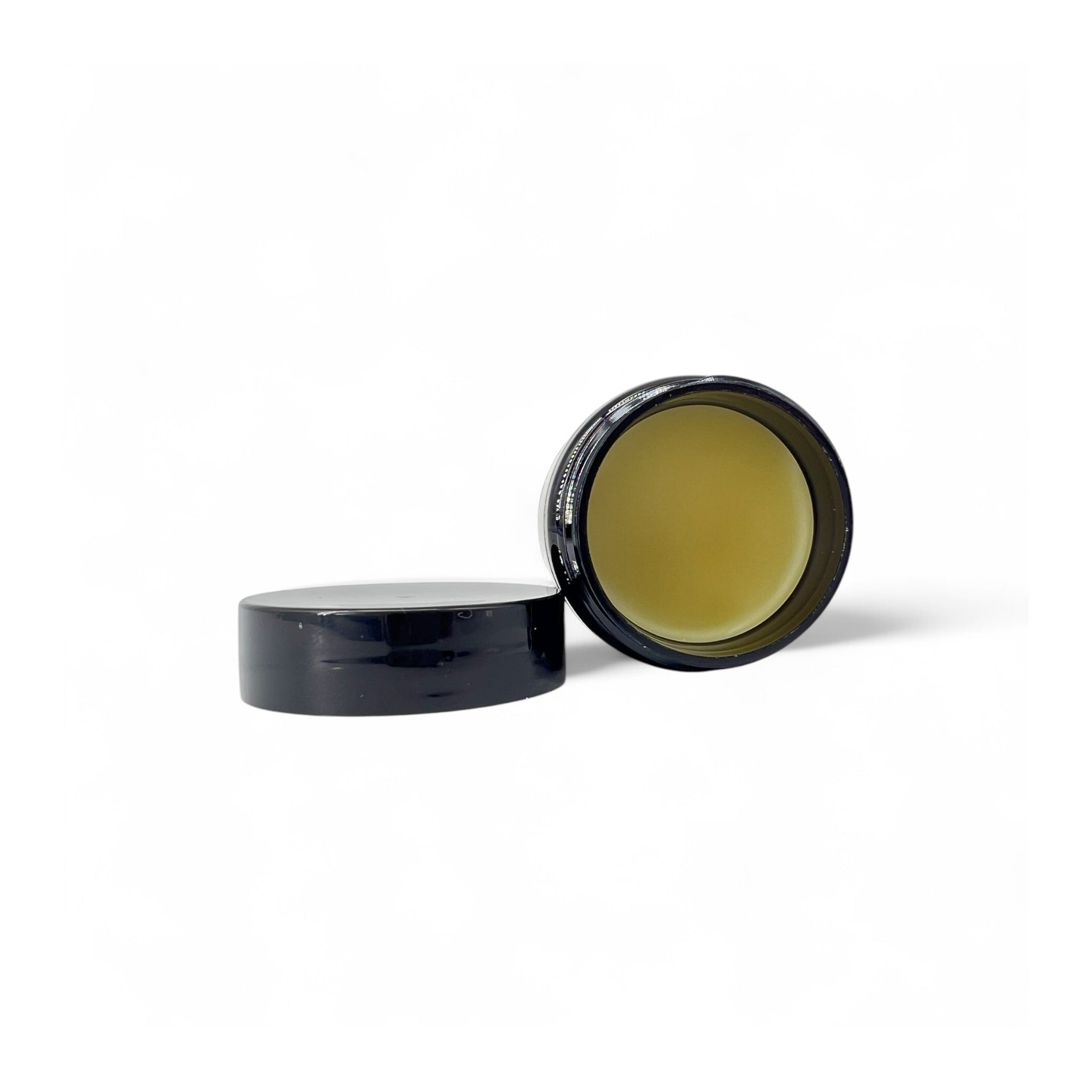 photo of 1oz of ball player's balm leather batting glove conditioner. cap is removed from container with container showing the product inside the container. the conditioner is a muted yellow color.