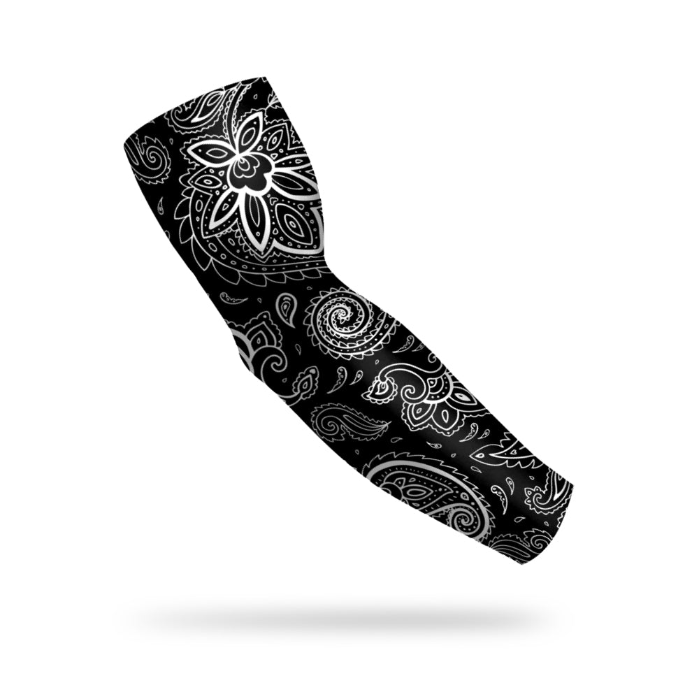 photo of a black compression sleeve with a white paisley pattern decorating it floating on a white background.