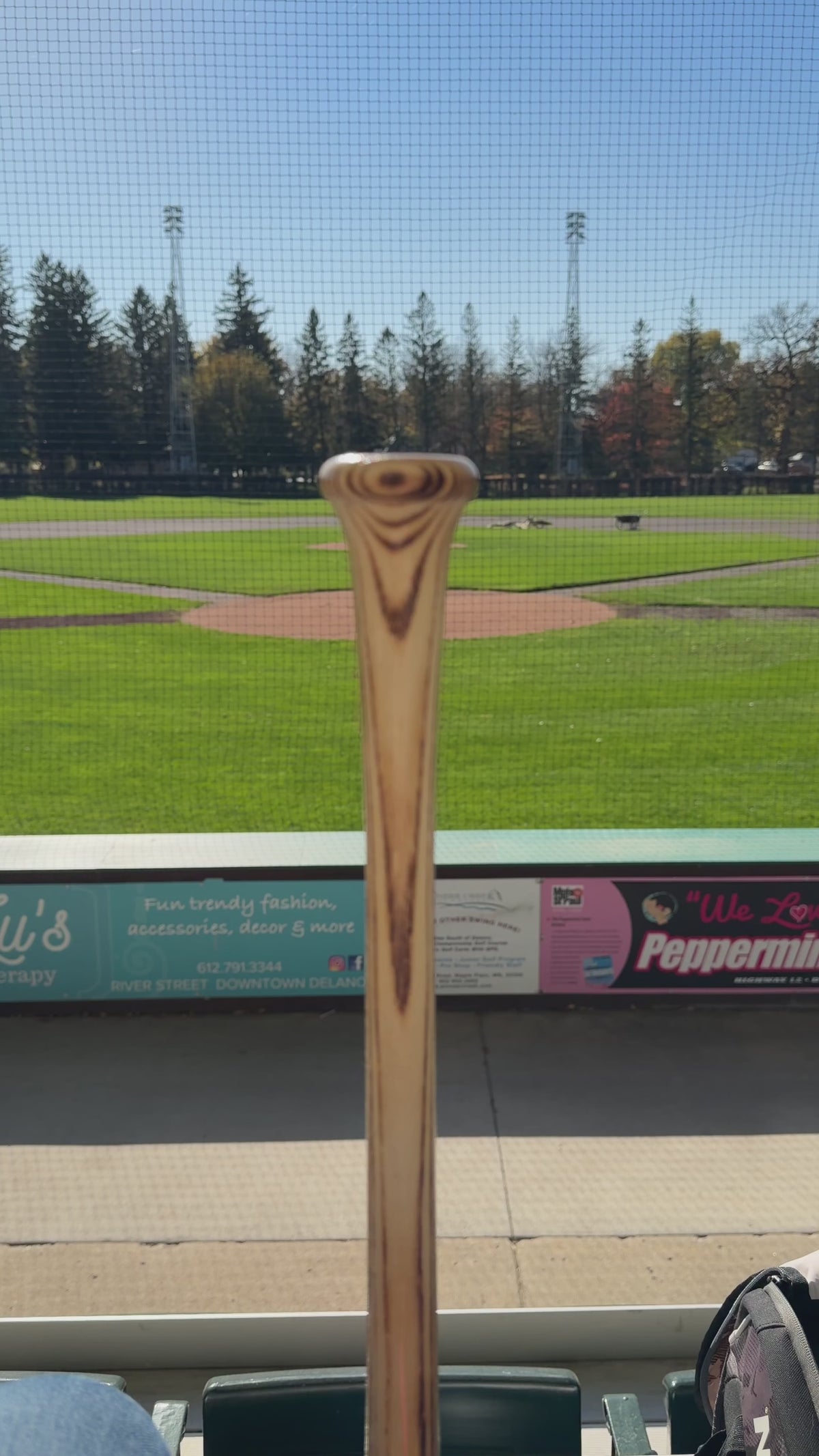 A vertical video showing how to properly wrap any Naked Grips Bat grip around a wooden baseball Bat.