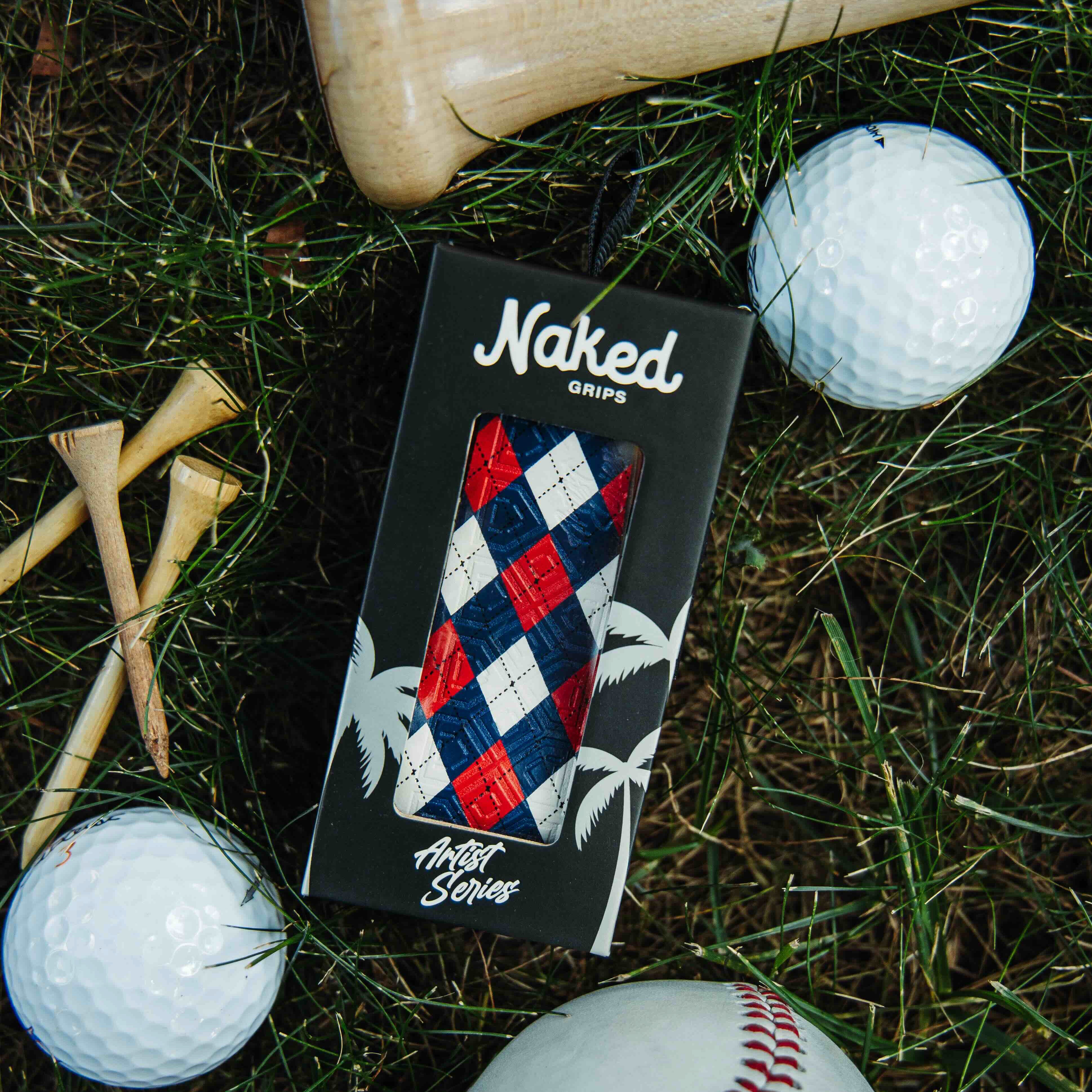 naked grips red white and blue bat grip in its box laying on grass surrounded by golf balls and batting tees. 